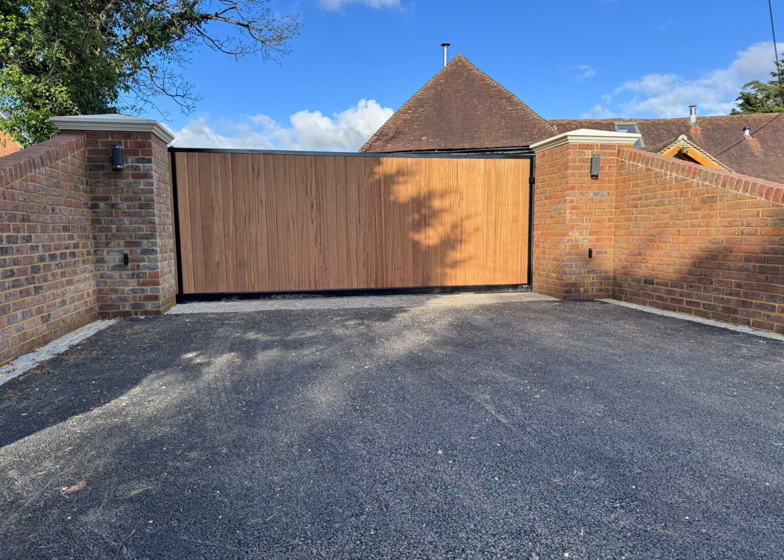 Newly installed driveway with sliding gate and brick boundary walls