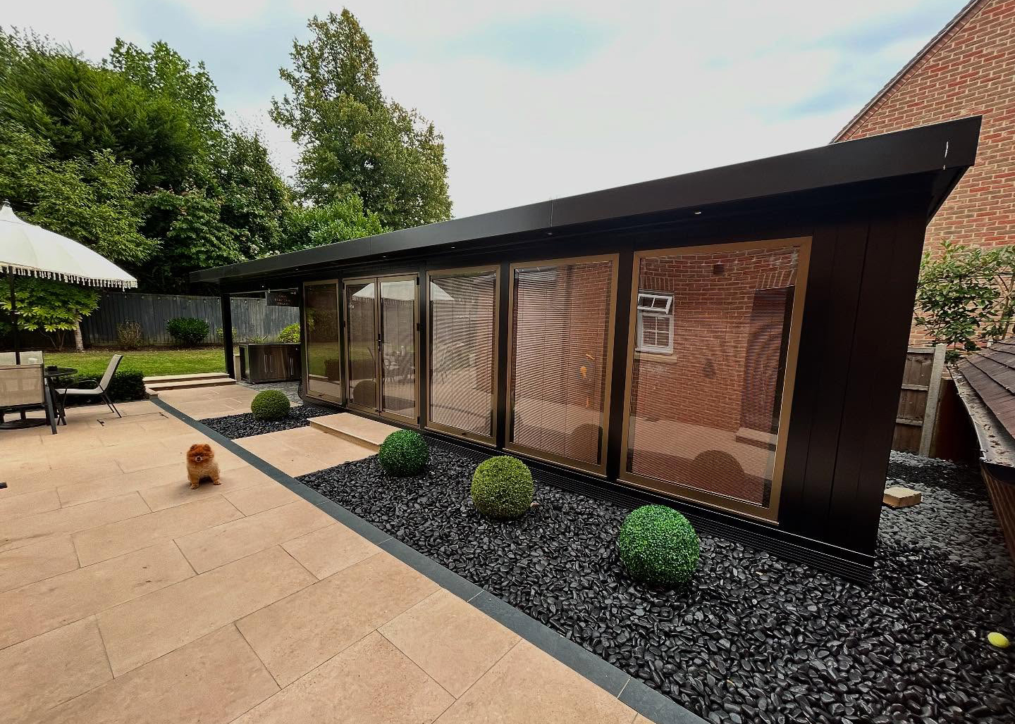 Modern garden room with paved terrace and decorative landscaping detail